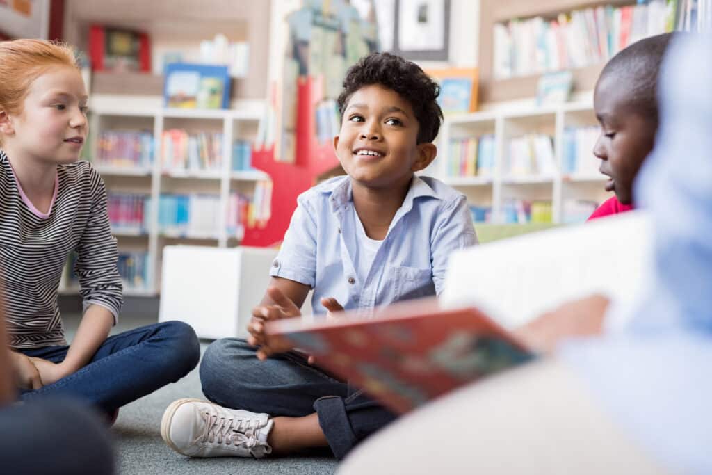 Kids listen to a story in a library. FVRLibraries and Camas Public Library top our list of free indoor things to do with kids in Vancouver and Clark County