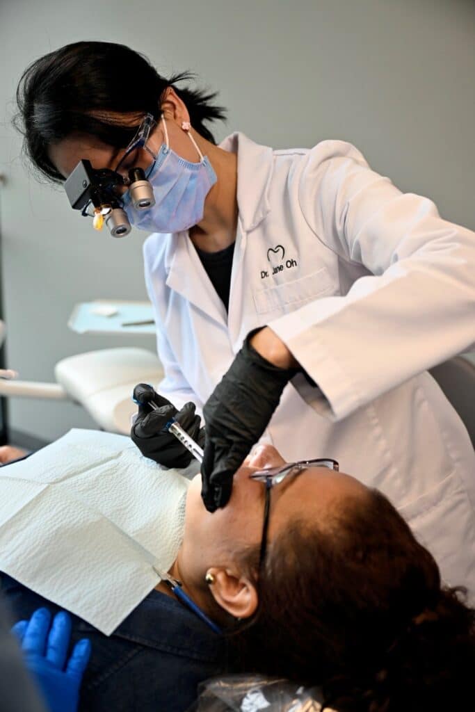 A dentist at Battle Ground HealthCare gives a patient a shot in the mouth. 