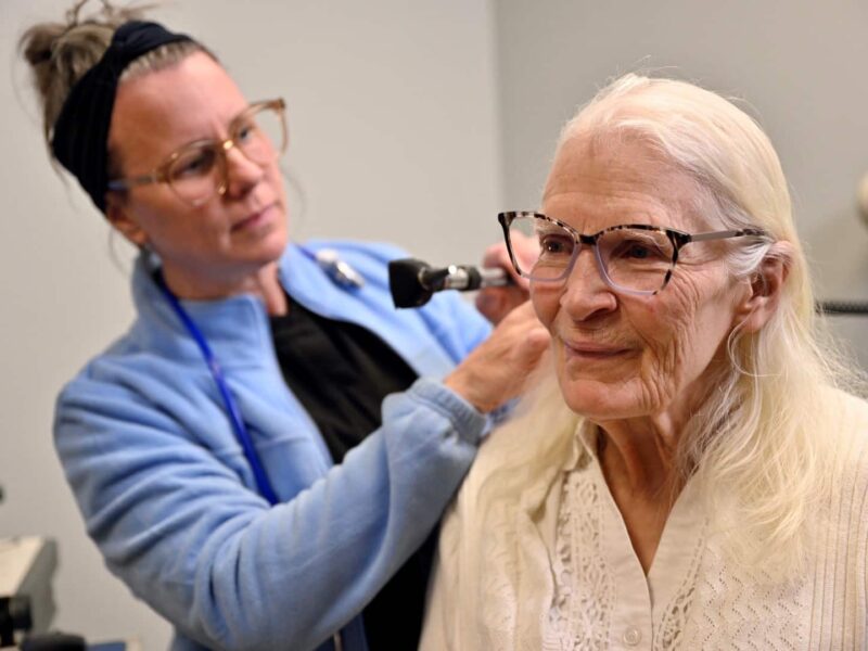 A woman gives another woman an exam in a clinic
