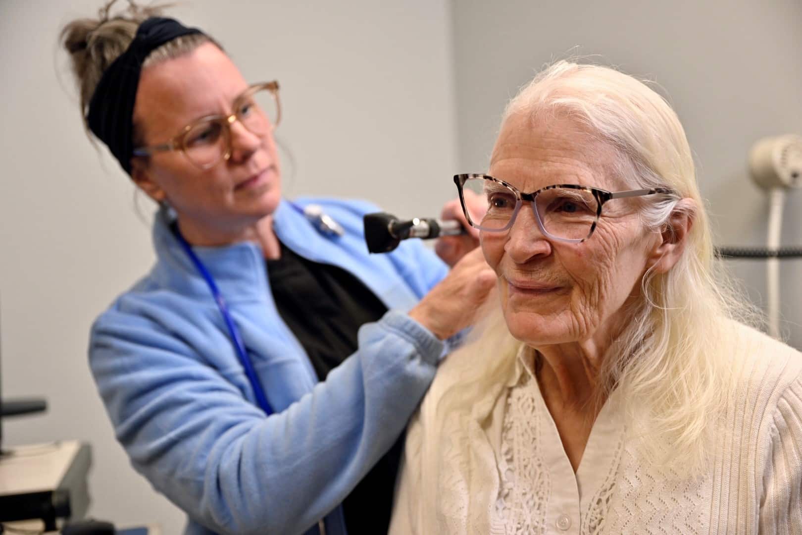 A woman gives another woman an exam in a clinic