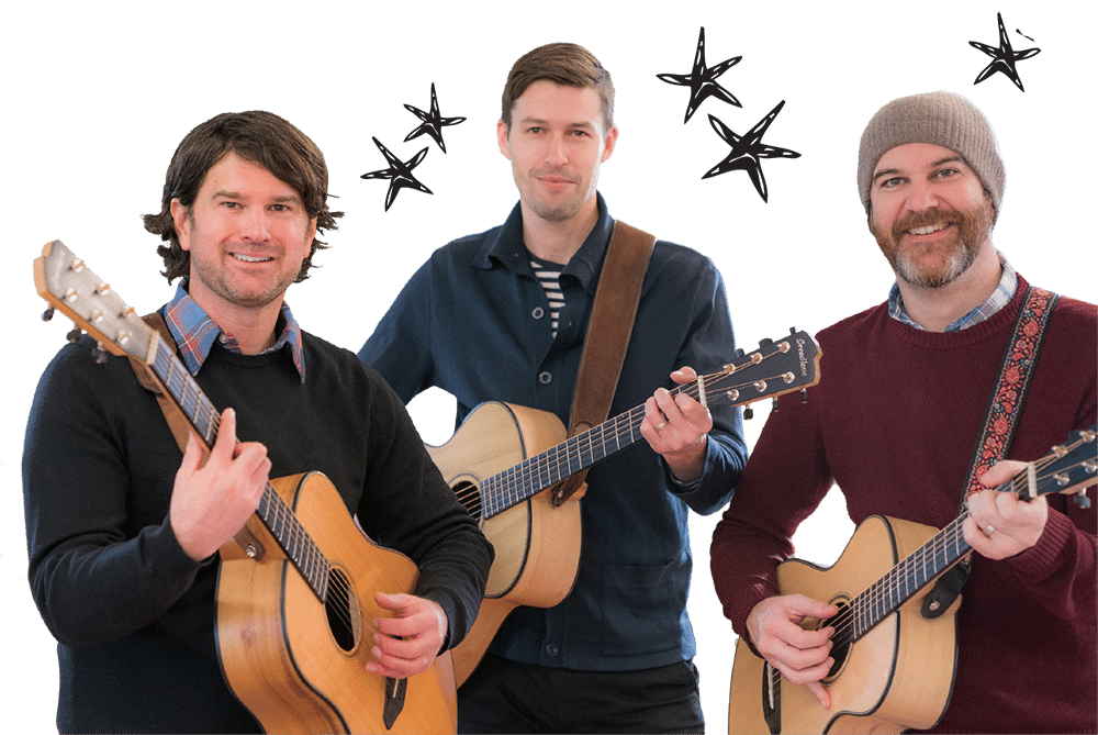 Three men smile while holding guitars