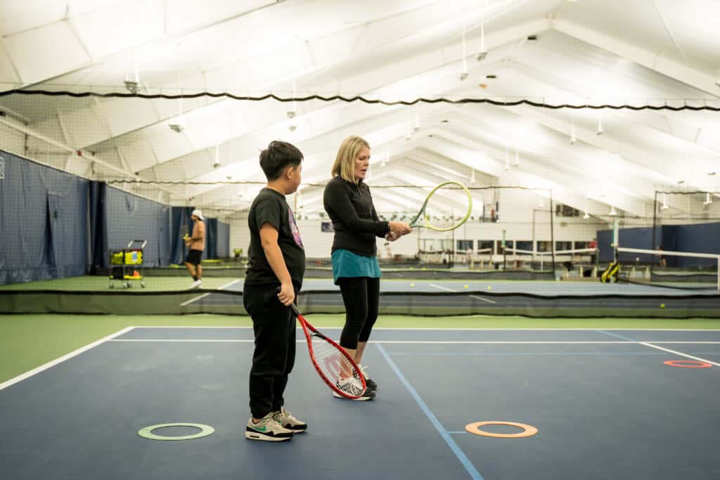 A woman and a child on a tennis court at Vancouver Tennis Center