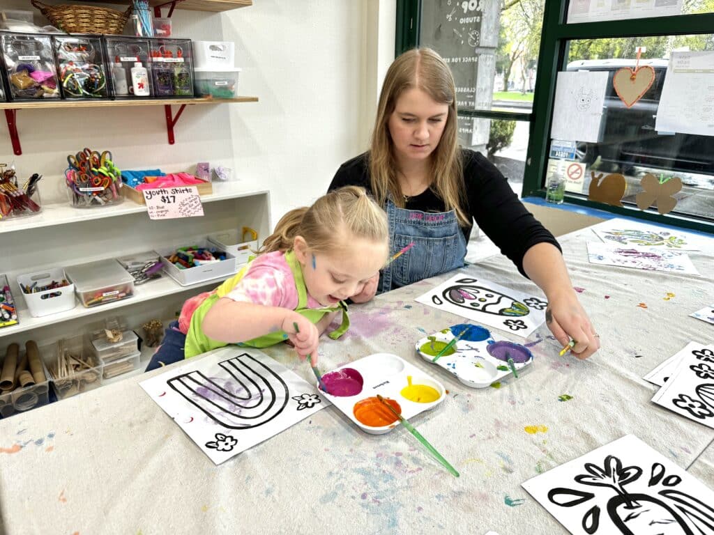 A woman and child paint in a studio. Art Spaces in Vancouver.